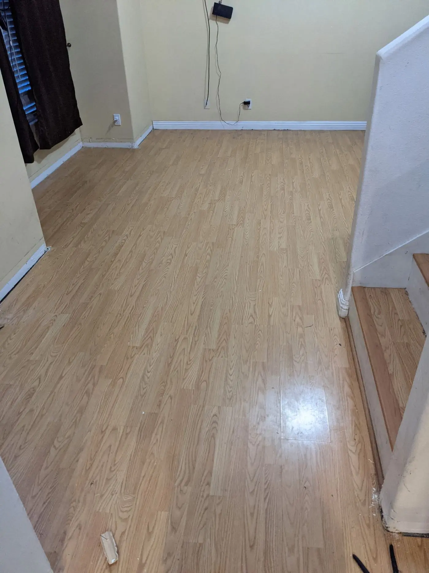 Finished plank flooring by the stairwell