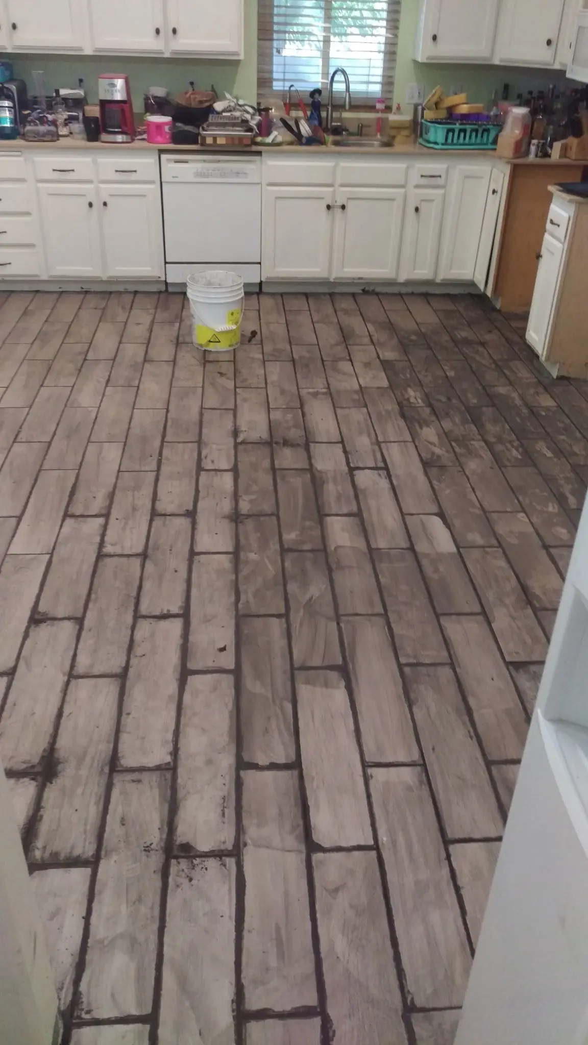 Finished tile flooring, full kitchen view